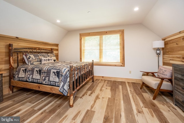 bedroom with light hardwood / wood-style flooring and vaulted ceiling