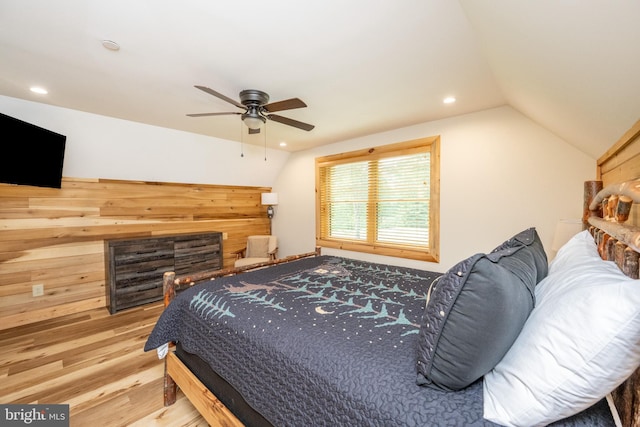 bedroom featuring hardwood / wood-style flooring, ceiling fan, and lofted ceiling