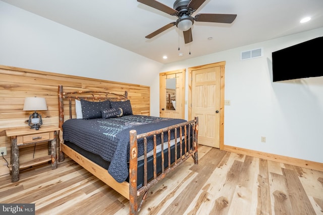 bedroom with wood-type flooring and ceiling fan