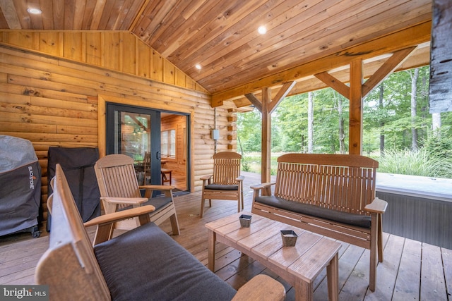 sunroom featuring vaulted ceiling and wood ceiling