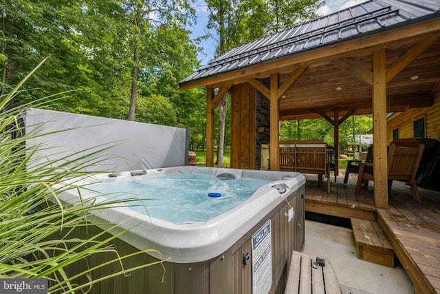 view of patio / terrace featuring a deck and a hot tub