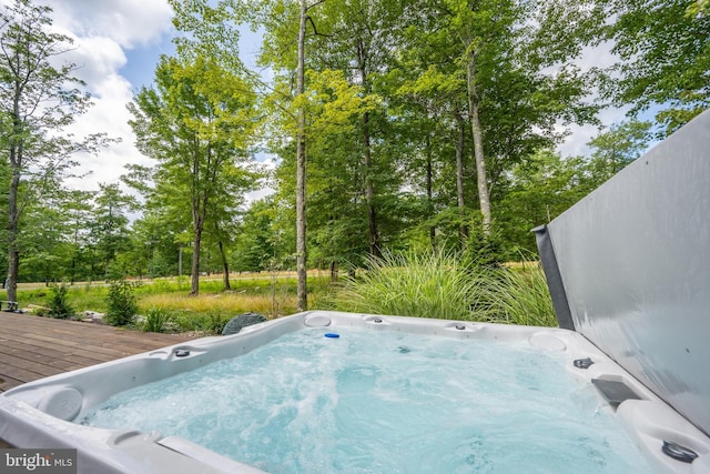 view of swimming pool with a deck and an outdoor hot tub