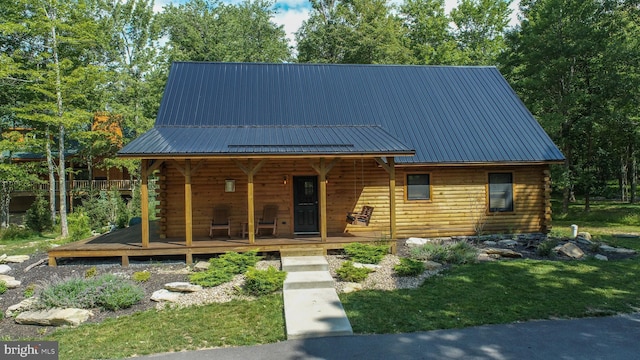 log home featuring a front yard and a porch