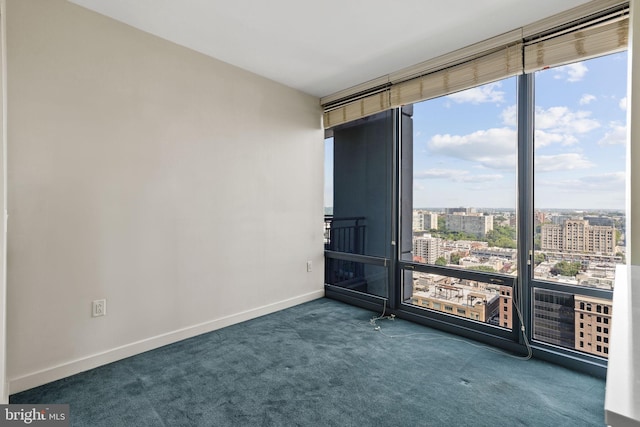 empty room featuring dark colored carpet and floor to ceiling windows