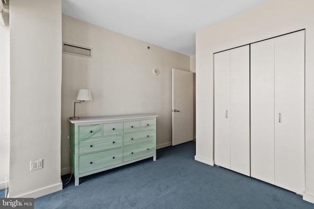 unfurnished bedroom with light colored carpet and a closet