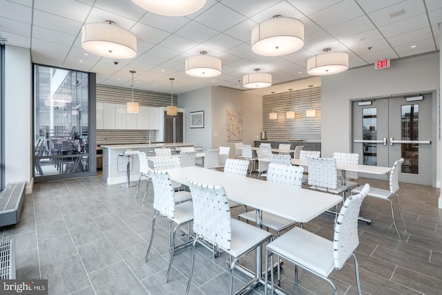 dining space with a paneled ceiling