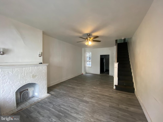 unfurnished living room featuring dark hardwood / wood-style flooring and ceiling fan