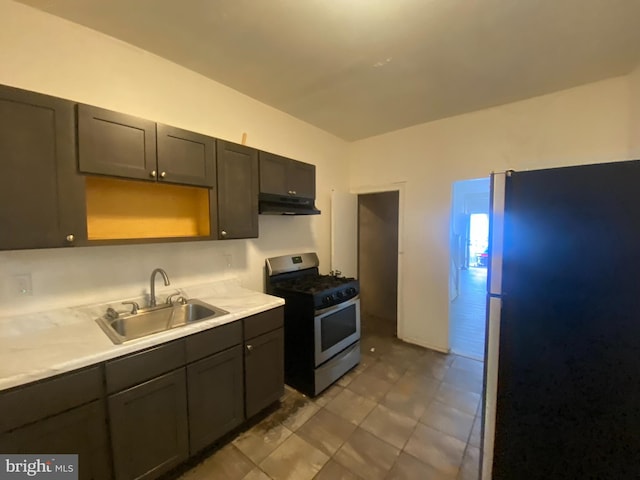 kitchen with dark brown cabinetry, sink, and stainless steel appliances