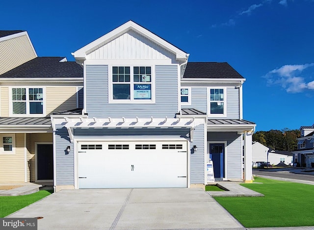 view of front of home featuring a front yard and a garage