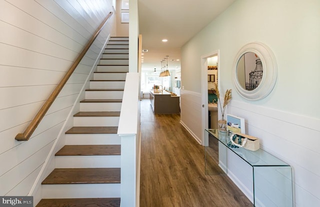 stairway featuring wood-type flooring