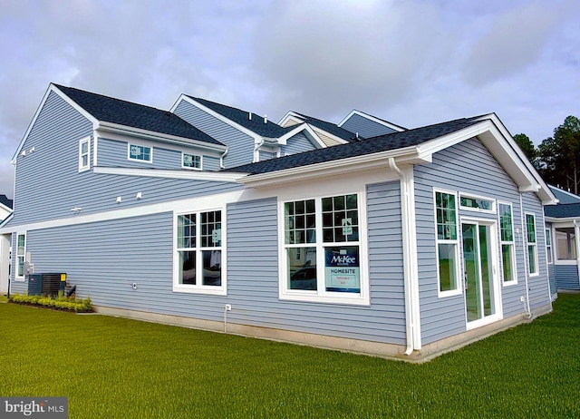 view of property exterior featuring central air condition unit and a yard