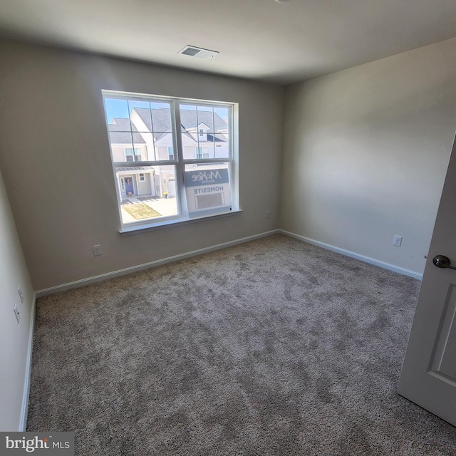 empty room with dark colored carpet