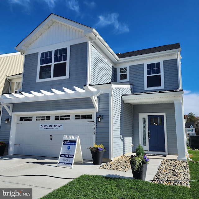 view of front of home with central AC unit and a garage