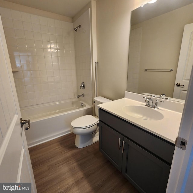 full bathroom with toilet, hardwood / wood-style flooring, vanity, and shower / bathing tub combination