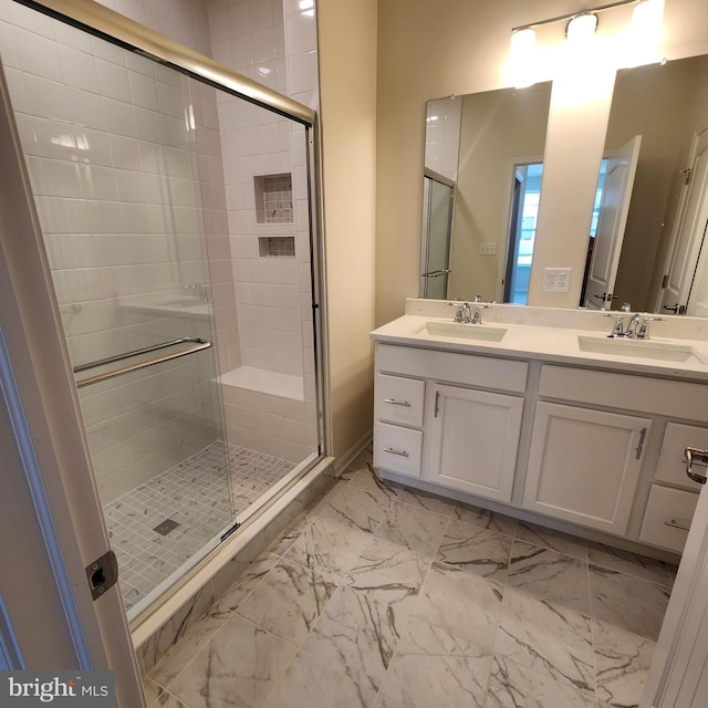 bathroom with a shower with door and vanity