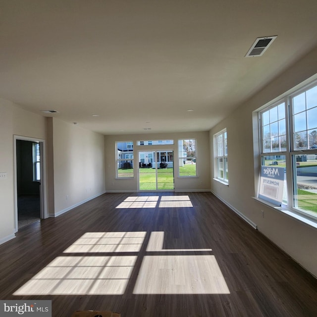 empty room with dark hardwood / wood-style flooring