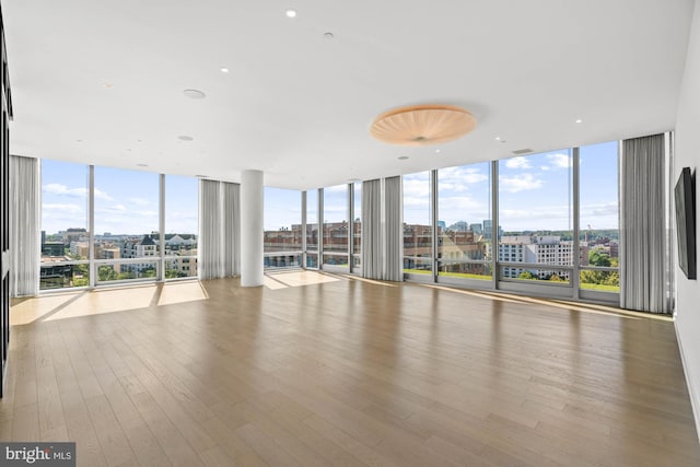 interior space featuring expansive windows and light hardwood / wood-style flooring