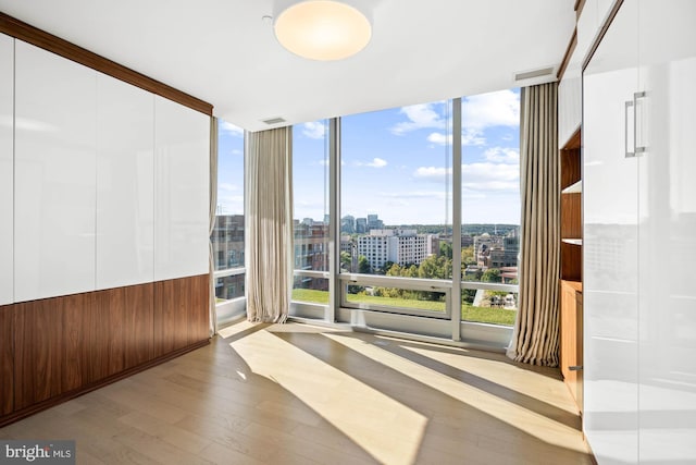 interior space featuring light hardwood / wood-style floors and a wall of windows