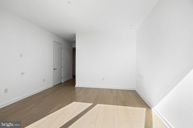 spare room with light hardwood / wood-style flooring