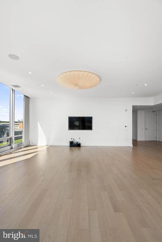 unfurnished living room with light hardwood / wood-style floors