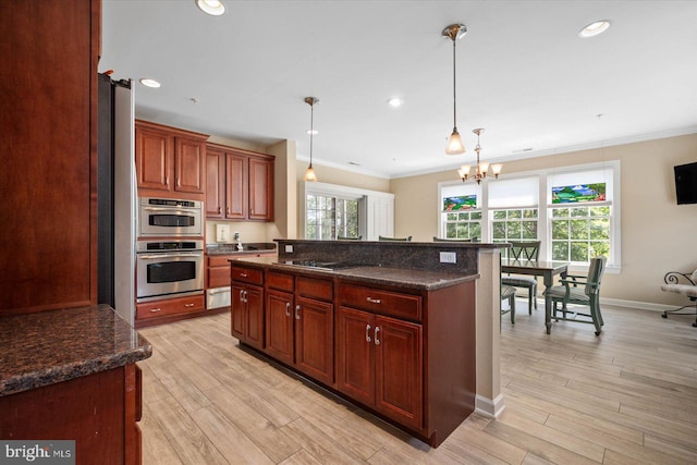 kitchen with black electric stovetop, hanging light fixtures, light hardwood / wood-style flooring, and a chandelier