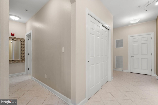 hall with light tile patterned flooring