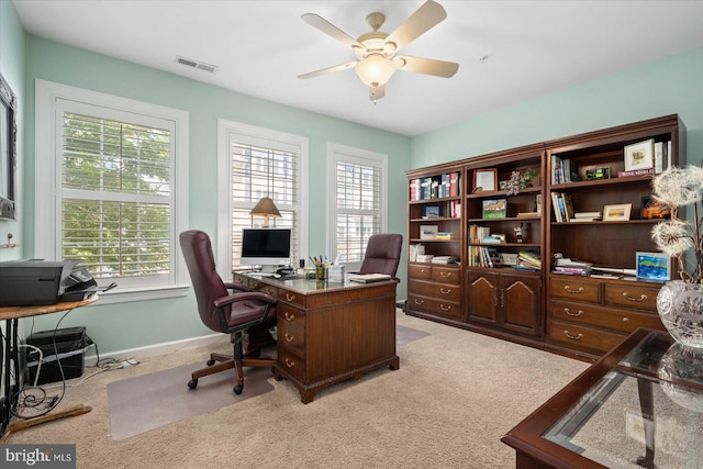 carpeted office featuring ceiling fan