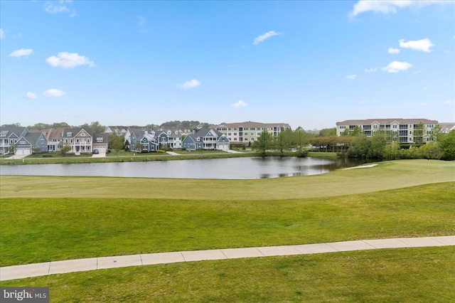 surrounding community featuring a lawn and a water view