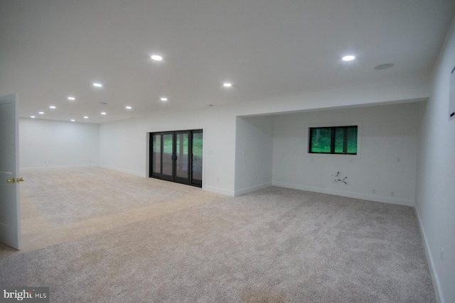 interior space with recessed lighting, light colored carpet, and baseboards