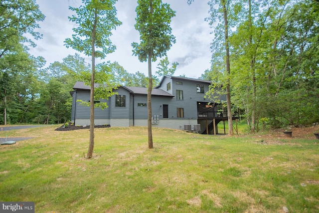 view of yard with a deck, central AC, and stairway