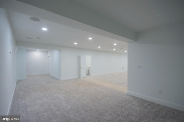 spare room with baseboards, light colored carpet, and recessed lighting