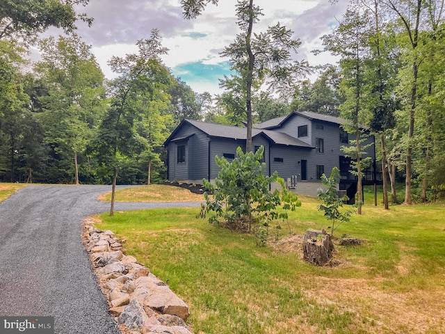 view of front of home with a front yard and driveway