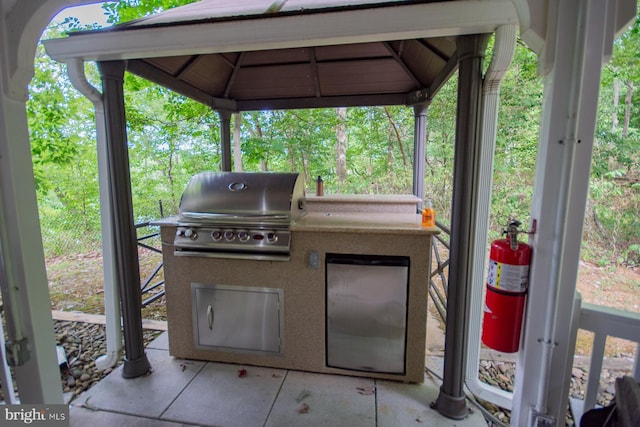 view of patio / terrace featuring a carport, grilling area, area for grilling, and a gazebo