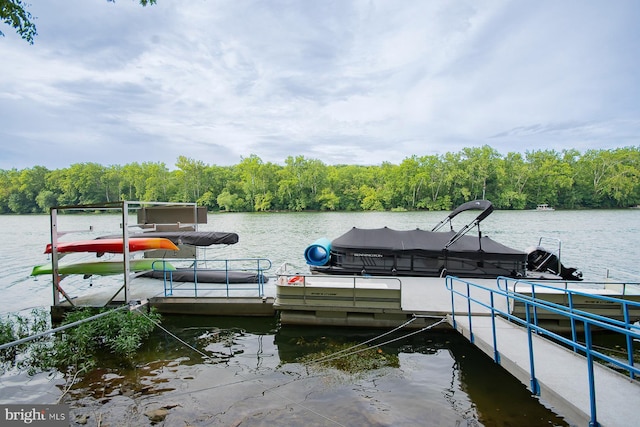 view of dock featuring a water view and a view of trees