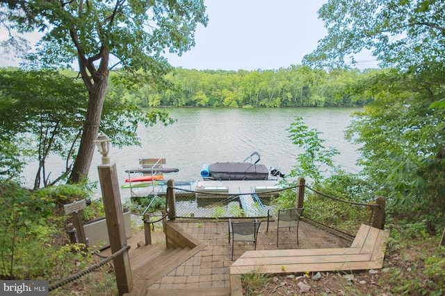 deck featuring a water view and a wooded view