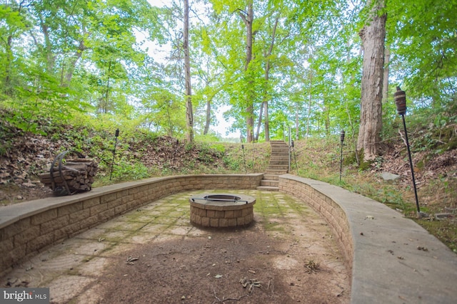 exterior space with a fire pit and stairway