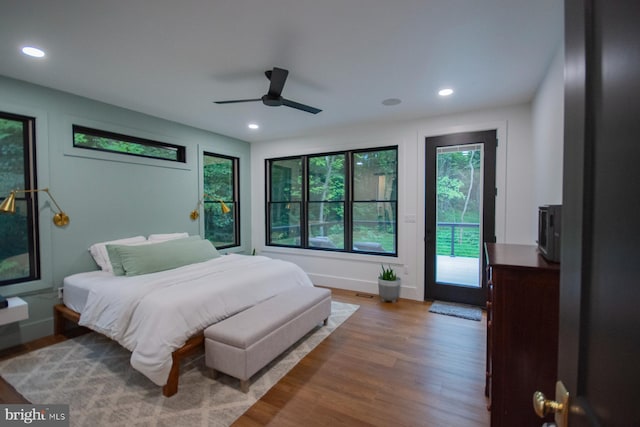 bedroom featuring light wood-type flooring, access to exterior, a ceiling fan, and recessed lighting