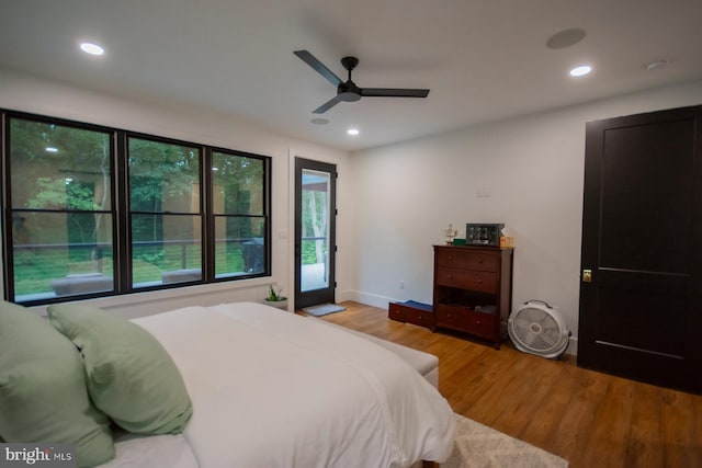 bedroom featuring access to outside, light wood finished floors, and recessed lighting