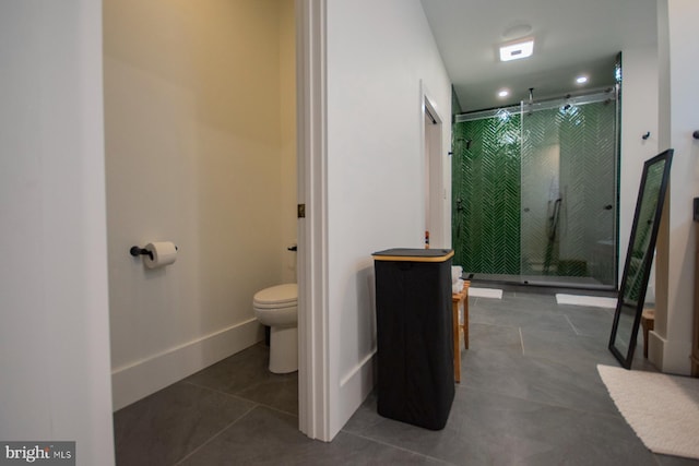 full bath with toilet, a shower stall, baseboards, and tile patterned floors