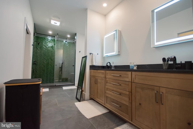 full bath with double vanity, a stall shower, a sink, and tile patterned floors