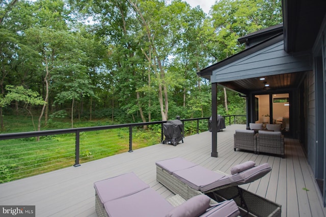 deck featuring outdoor lounge area and grilling area