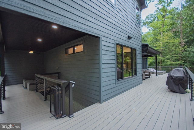 wooden terrace featuring a grill