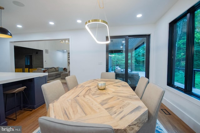 dining room featuring light wood-style flooring, baseboards, and recessed lighting