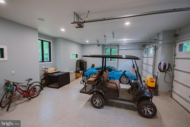 garage with a garage door opener and recessed lighting