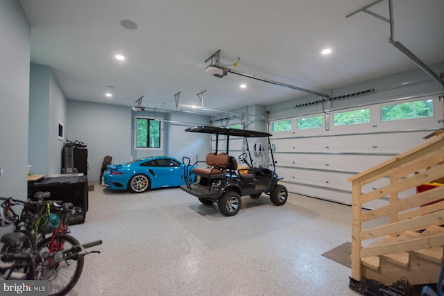 garage with recessed lighting and a garage door opener