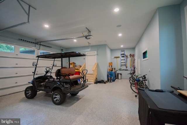 garage featuring a garage door opener and recessed lighting