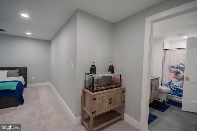 bedroom featuring baseboards, recessed lighting, connected bathroom, and light colored carpet