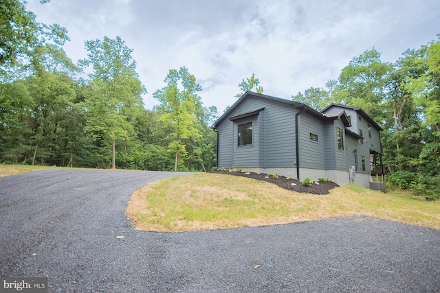 view of side of home featuring a yard and central air condition unit