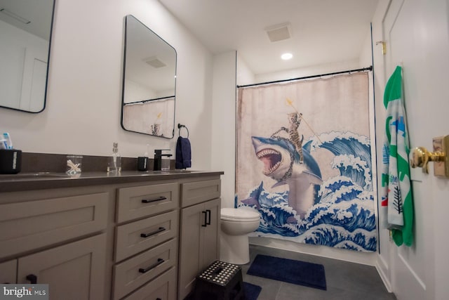 bathroom with toilet, tile patterned flooring, and vanity