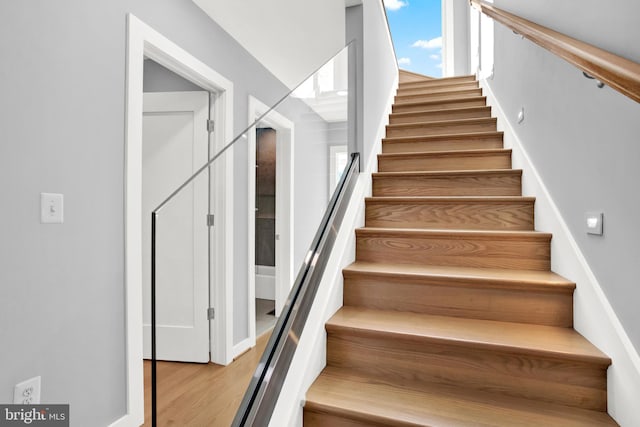 stairway featuring wood finished floors